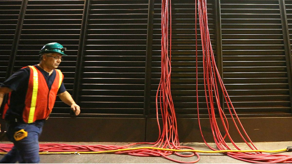 A power company worker outside a generator