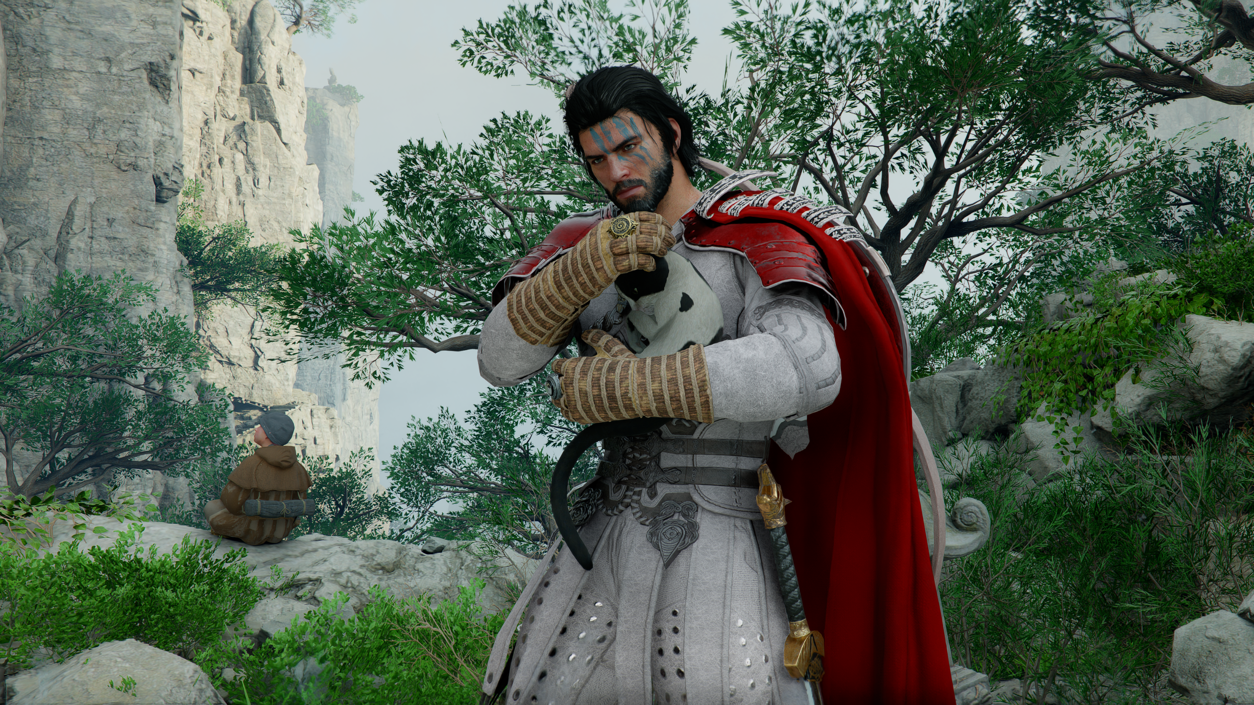 Kliff petting a kitten in Crimson Desert