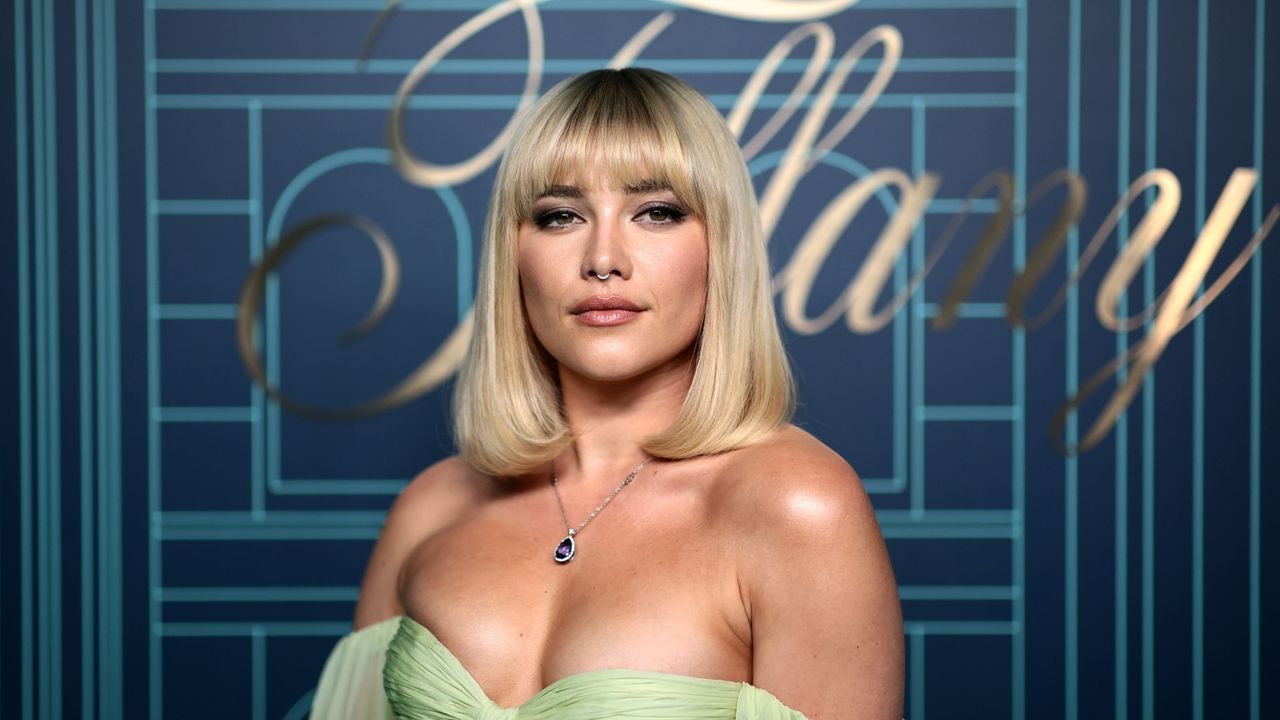 Florence Pugh&#039;s kitchen shelving is a hit with our experts. Florence, a white, is pictured wearing a green dress with blonde hair and a fringe, standing in front of a blue background that says &#039;Tiffany&#039;