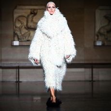 model wearing a white shaggy coat at the erdem autumn/winter 2024 show