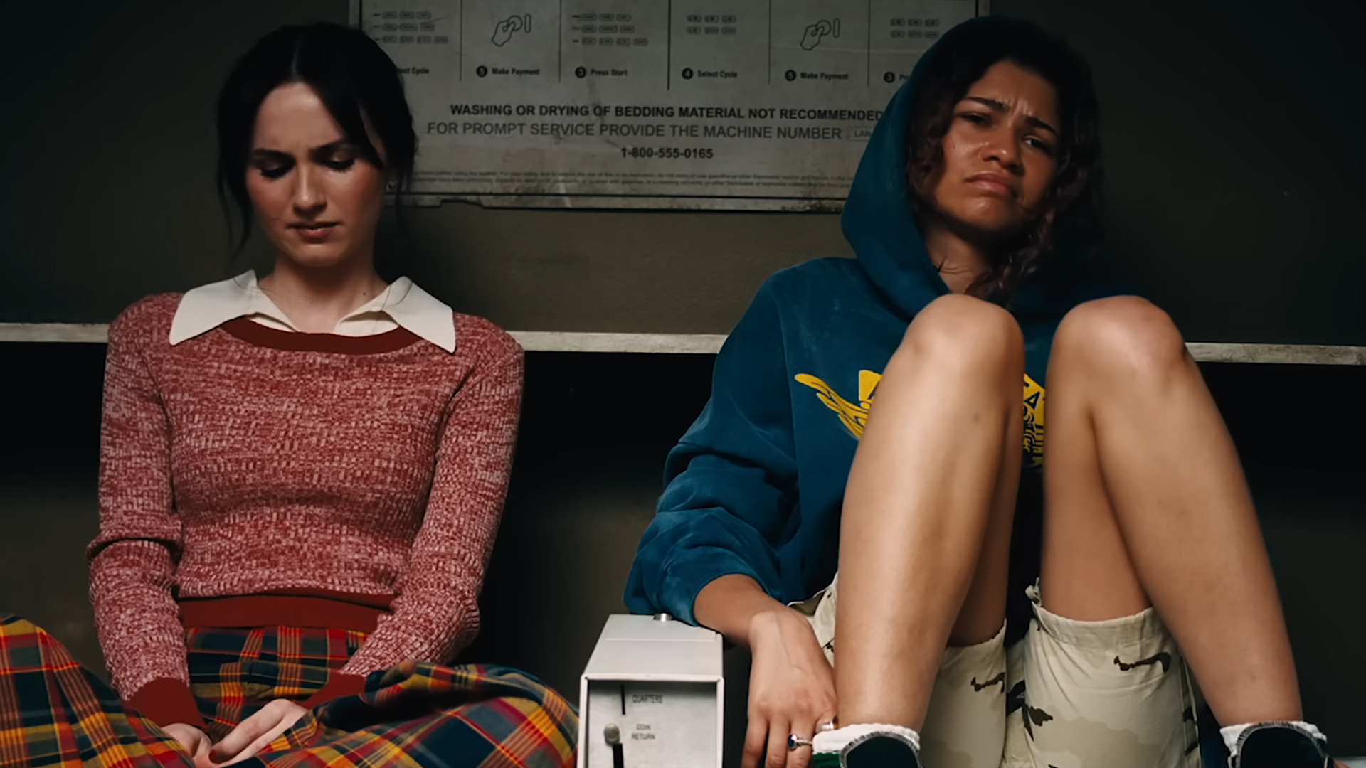 Lexi (Maude Apatow) and Rue (Zendaya) looking very sad in a laundromat