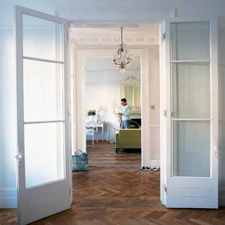 hallway with white door and wooden flooring