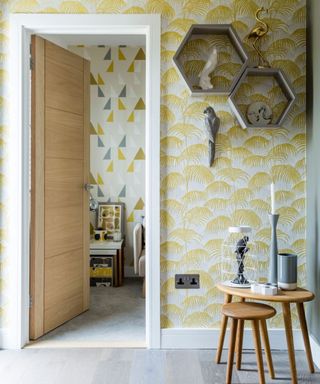 hallway with yellow wallpaper and table