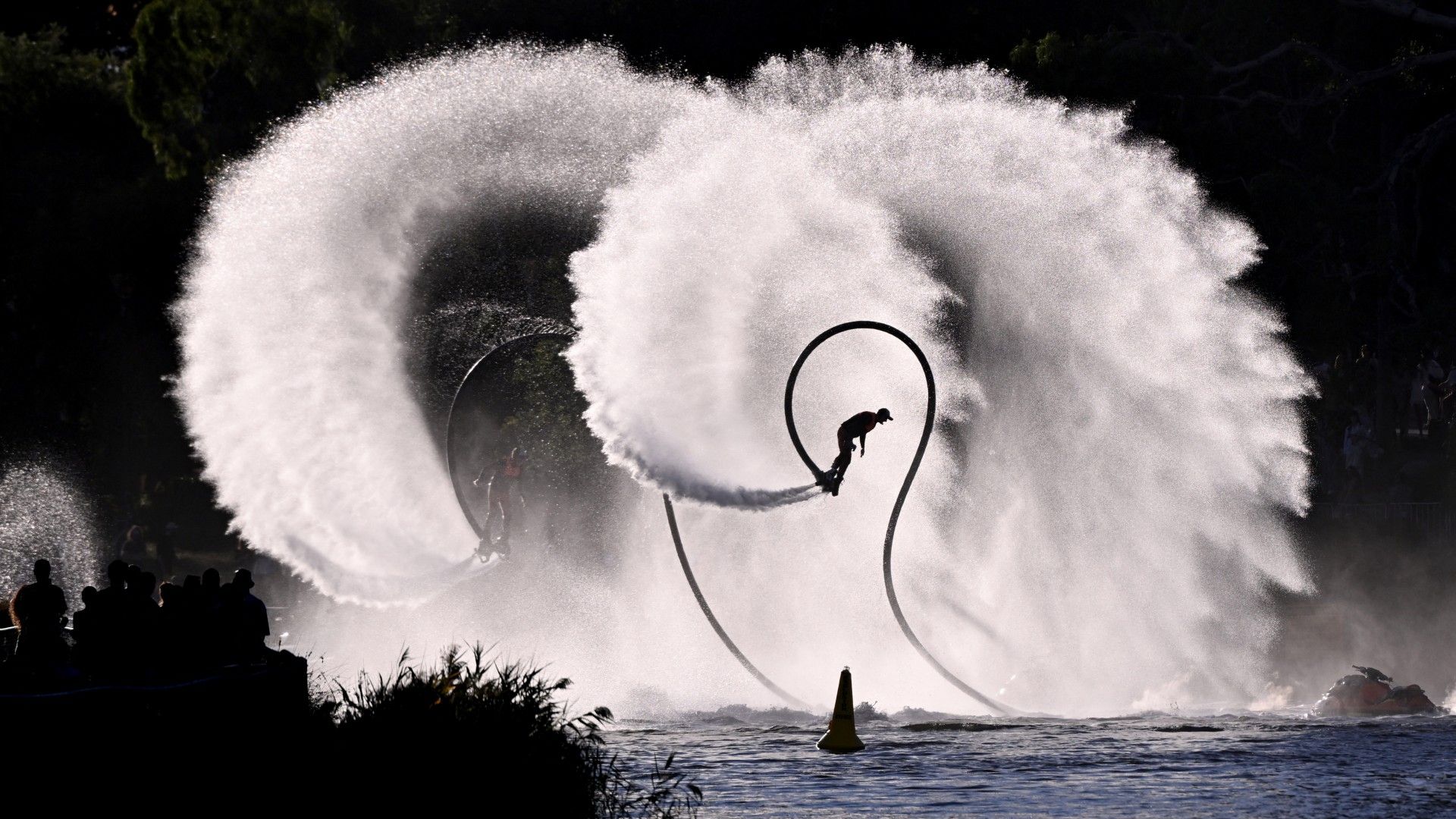 
                                A water-propelled jet-pack pilot soars above the Yarra River during Melbourne&#039;s annual Moomba Festival
                            