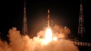 A red and white India Space Research Organisation rocket launches the Space Docking Experiment satellites into orbit on Dec. 30, 2024.