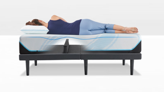 A woman sleeping on her side on the Tempur Pedic Tempur Ergo bed with a mattress on