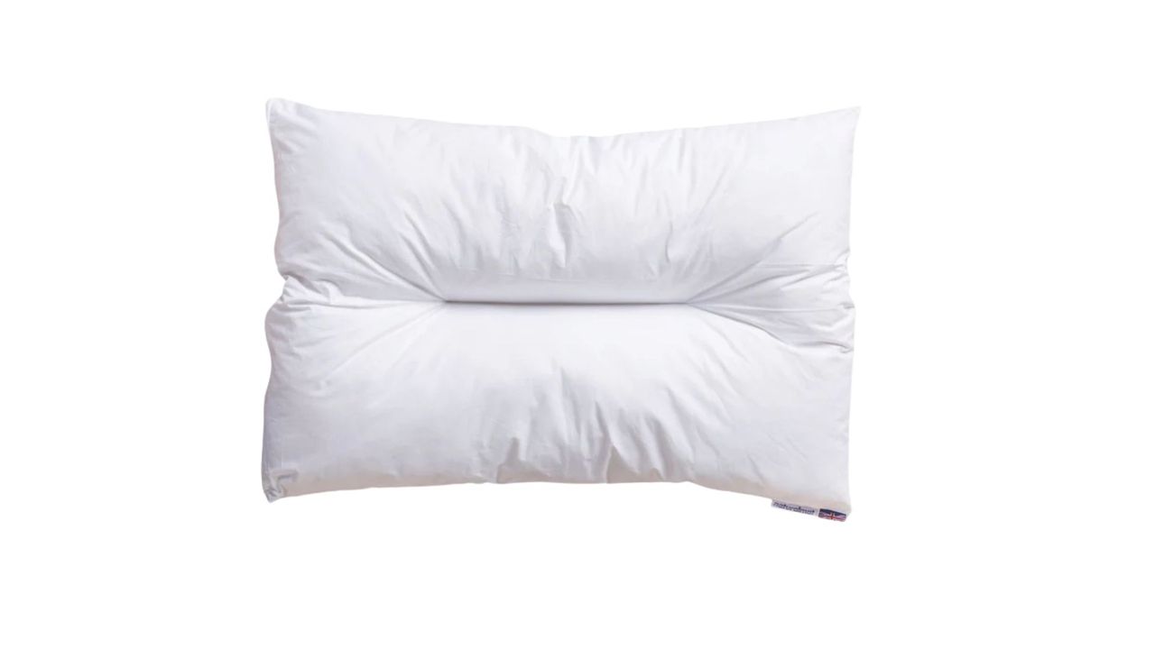 The Naturalmat The Centre Stitched Wool Pillow on a bed