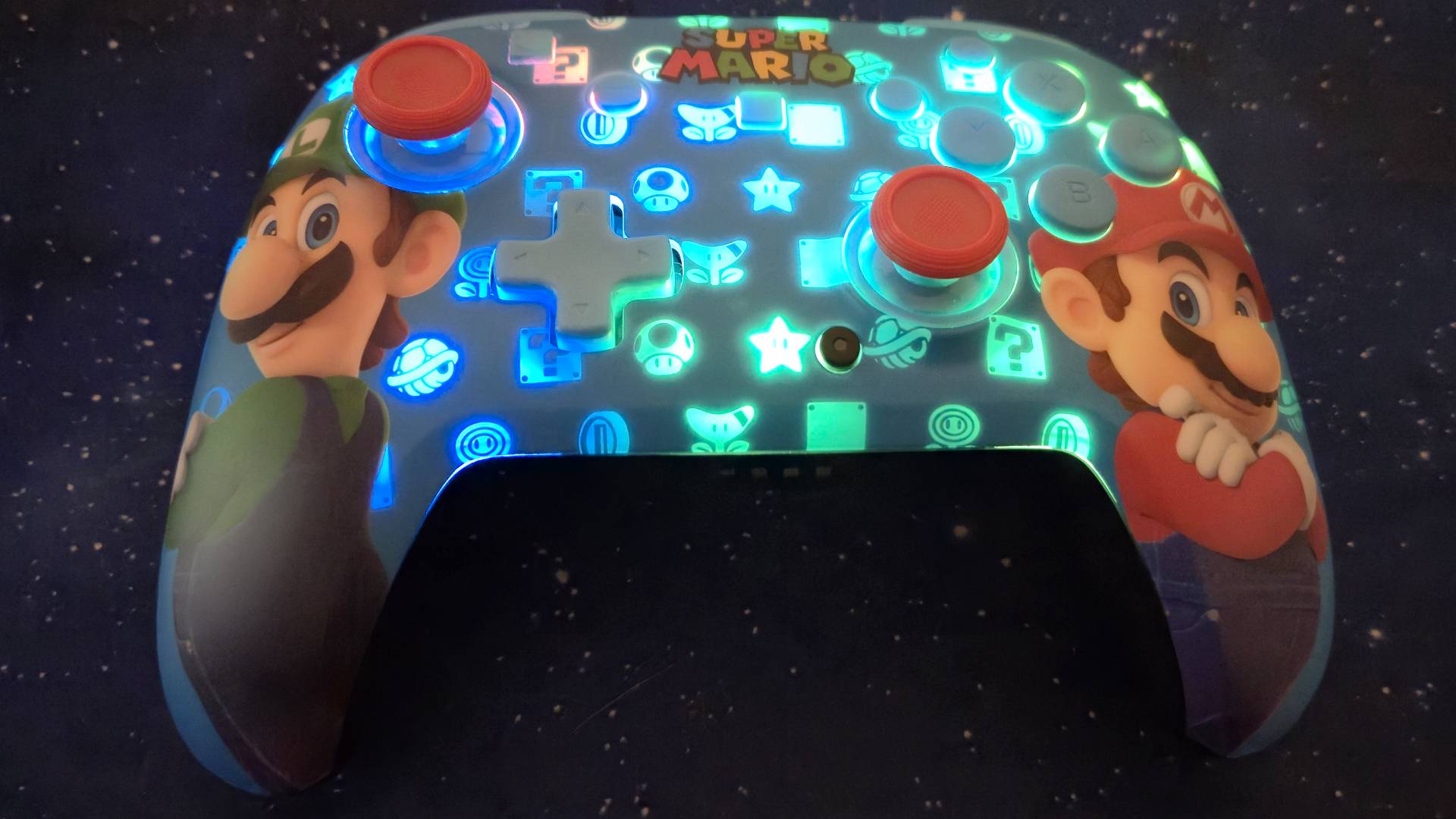 Photo of the Mario and Luigi Rematch Switch 2 controller in a dark lit room.