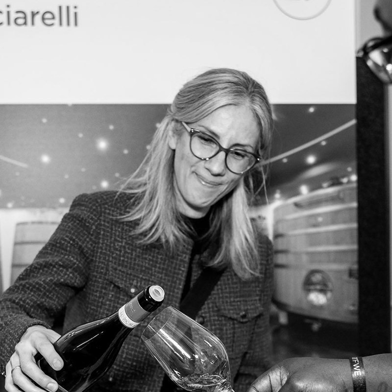 Photo of Michela Nassiz pouring a glass of wine