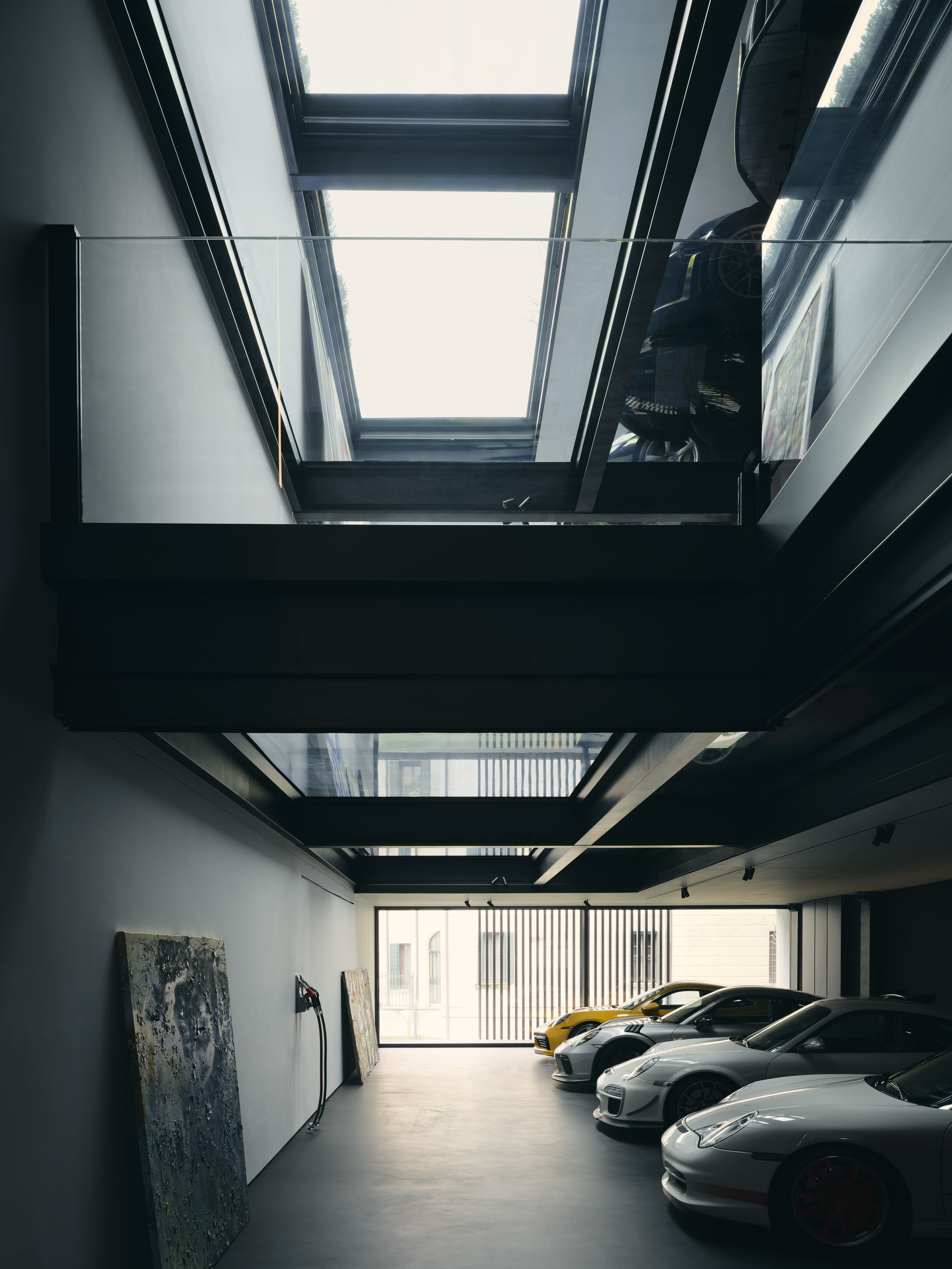 The client's Porsche collection is arranged across a number of floors, connected via a car lift