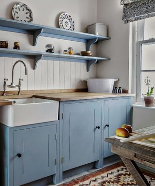 soft blue kitchen scheme with chalky blue cabinets and farmhouse ceramic sink