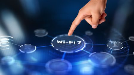 A finger pointing at a blue screen with the text "Wi-Fi 7"