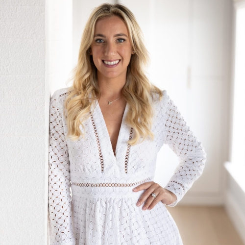 Image of a woman in a white eyelet lace dress