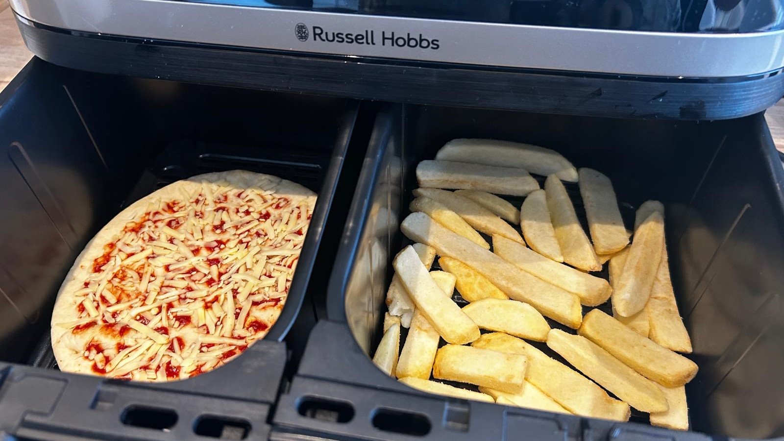 Frozen fries and pizza inside Russell Hobbs Satisfry air fryer