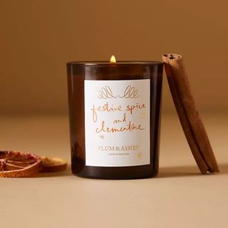 An orange scented candle - best Christmas scents