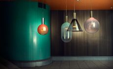 4 coloured glass bulbs hanging from the ceiling