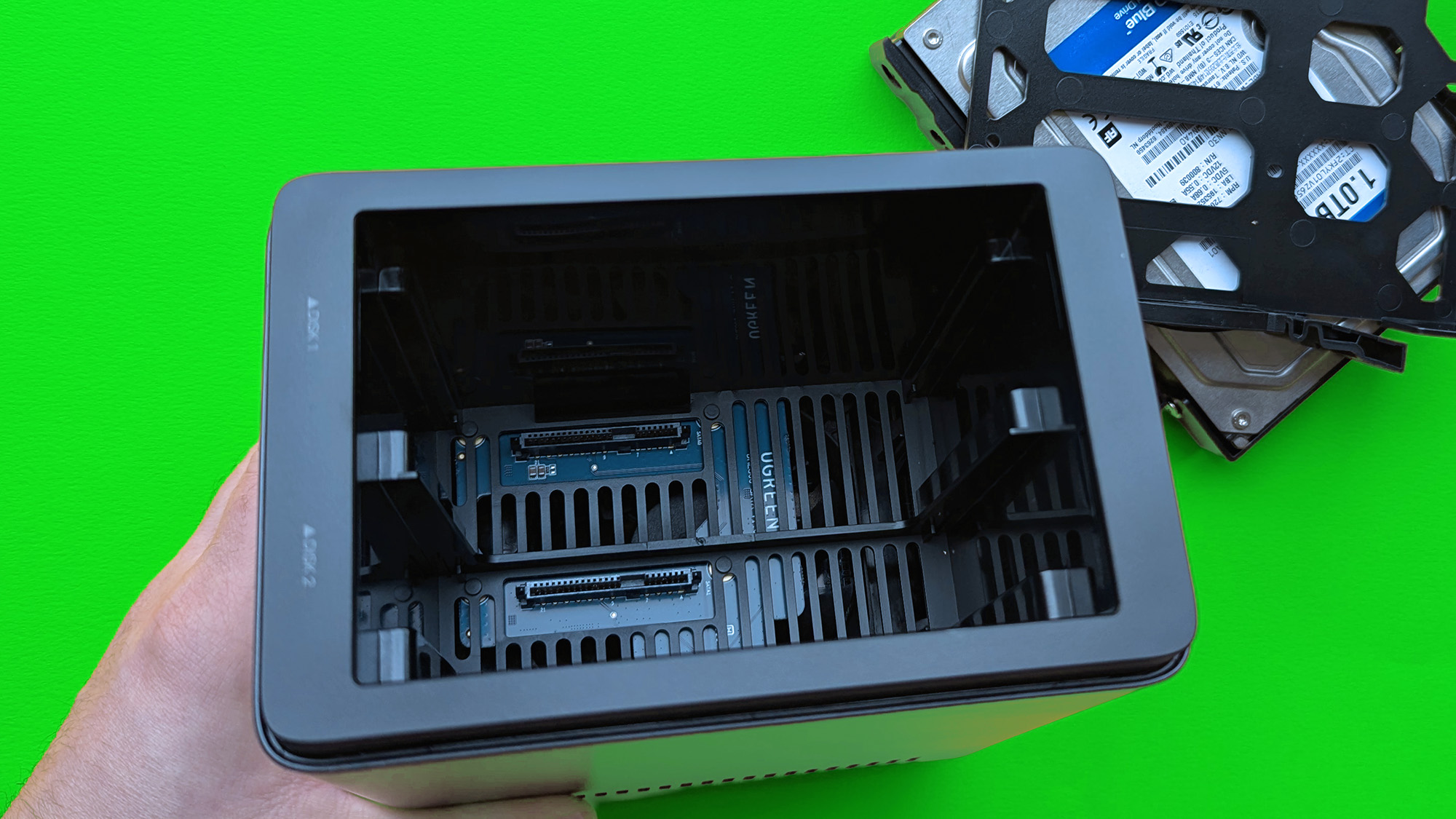 UGREEN NASync DH2300 on a green card paper background