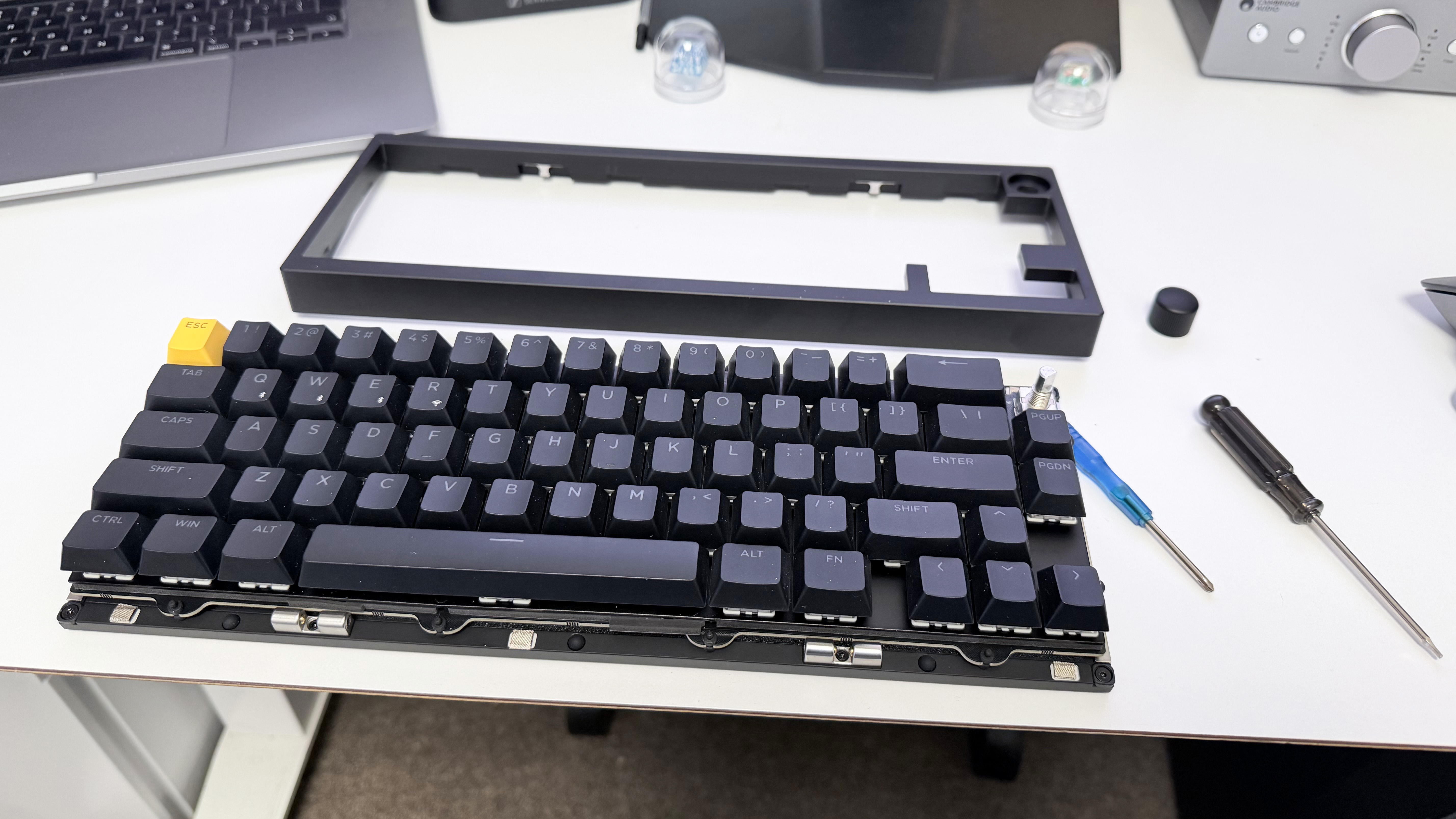 The Lemokey P2 HE being modified on a white desk