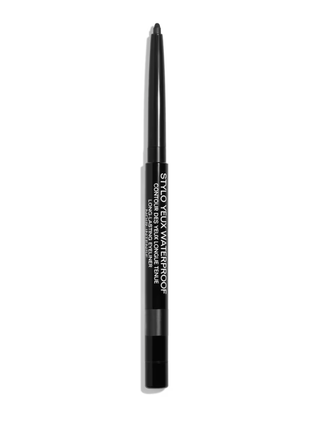 a tube of black eyeliner from chanel in front of a plain backdrop