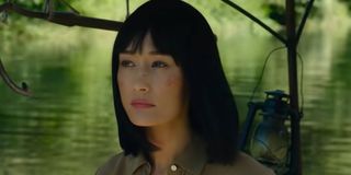 Maggie Q on the river in The Protege
