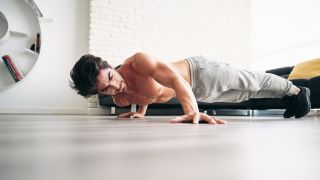 Man performs an archer press-up