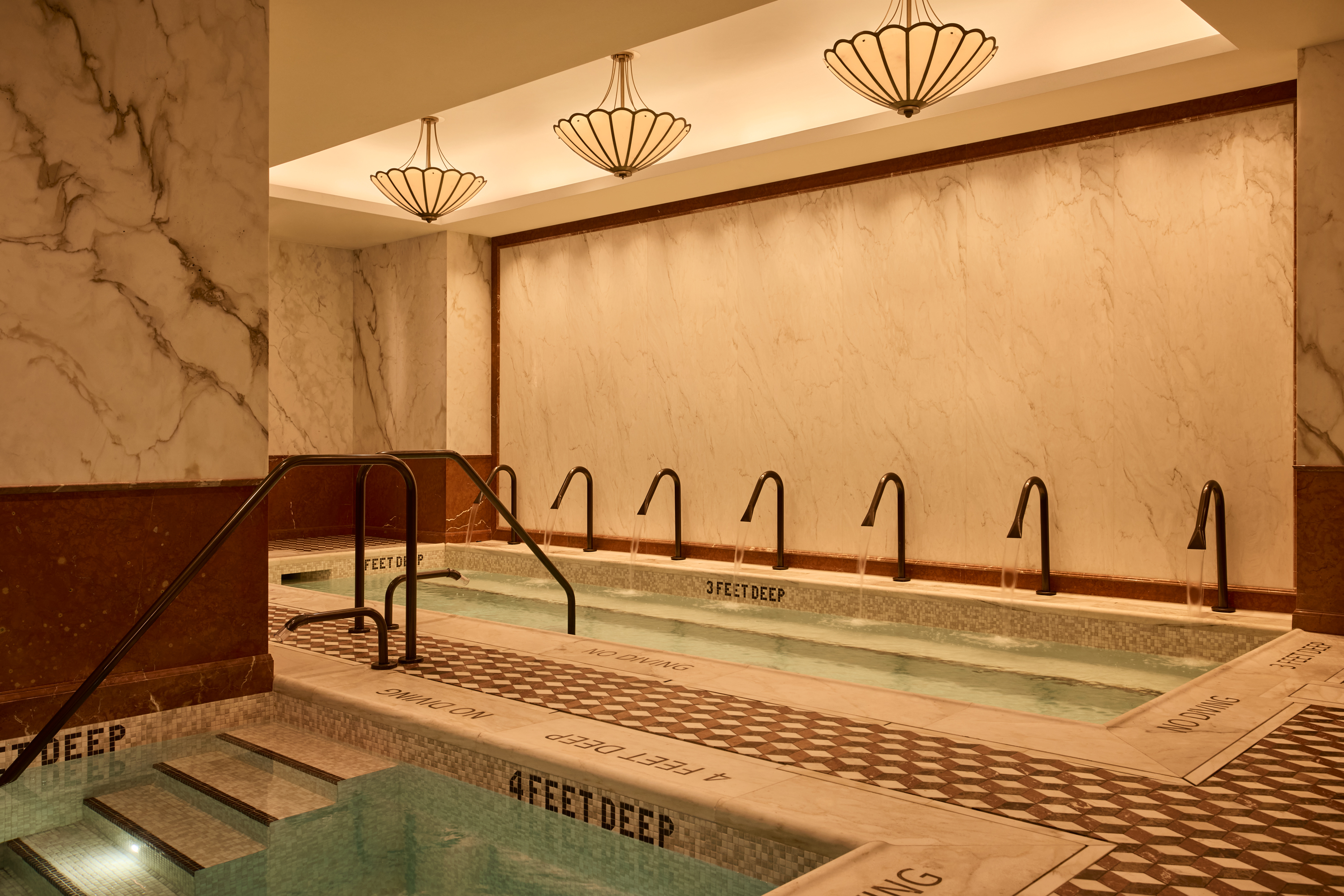 A view of pools surrounded by marble at Moss, a new private club in NYC's midtown.