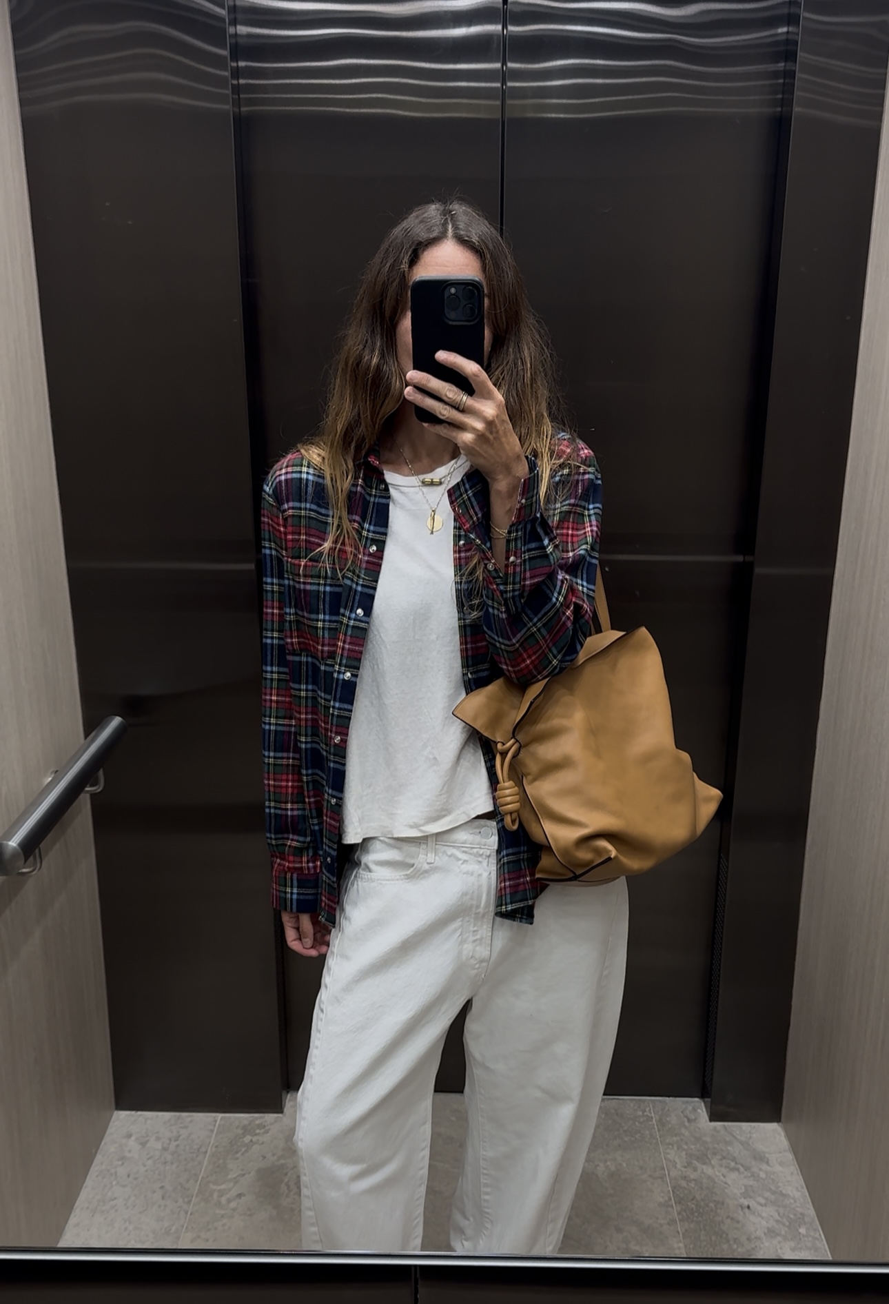 Angie wears a Bode sweater