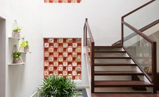 The Manjeri Residence's main staircase with triple height and jaali walls