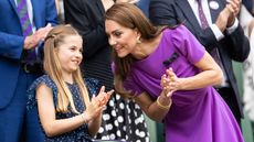 Catherine, Princess of Wales talks with Princess Charlotte of Wales in the Royal Box at the start of the Mens Singles Final at Wimbledon on July 14th, 2024
