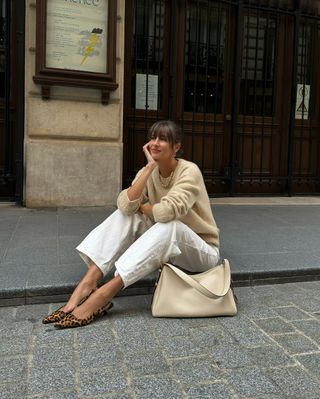 @juliesfi wearing leopard print flats with white jeans