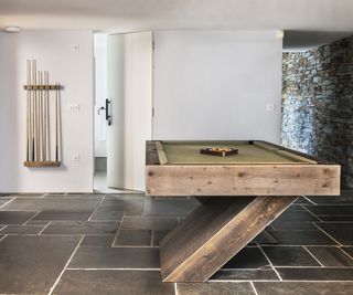 Wooden pool table, stone floor