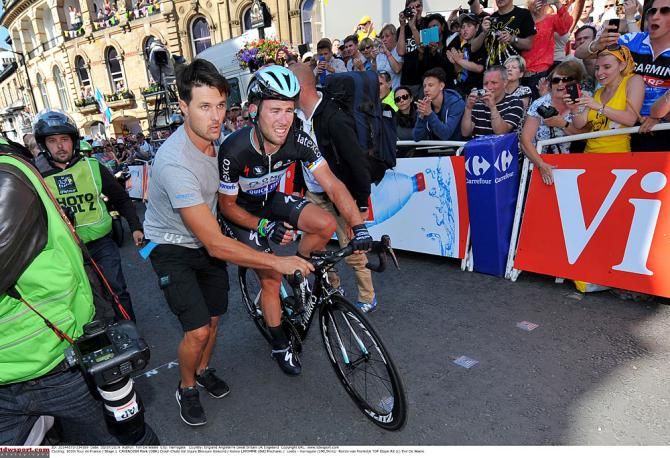 Mark Cavendish gets back on his bike to finish the stage
