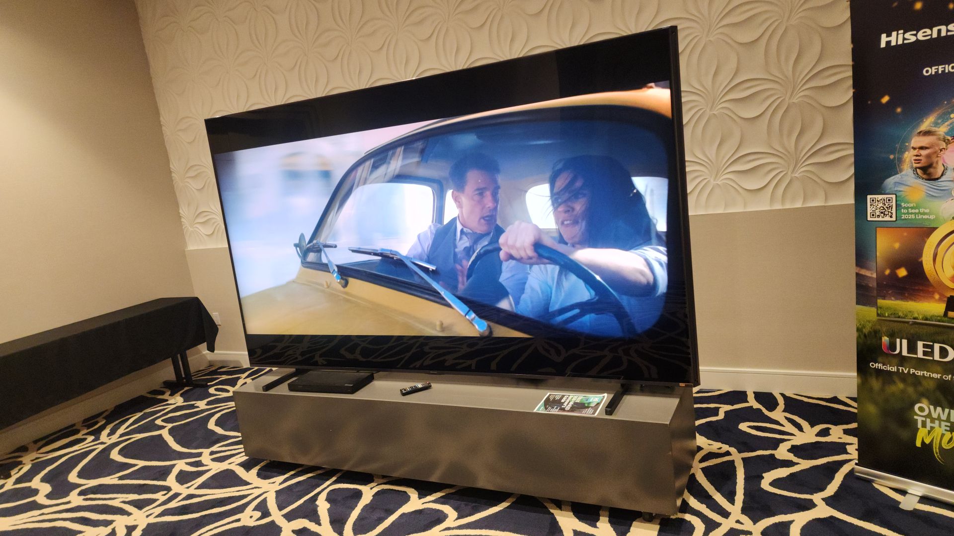 Hisense 116UX showing image from Mission Impossible onscreen