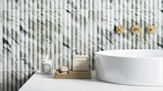 Close up image of a round bathroom basin with a textured wall tile splashback