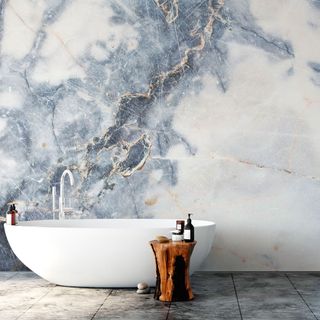 bathroom with marble wallpaper and bathtub