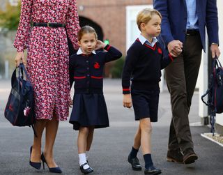 Princess Kate and Prince William walking with Princess Charlotte and Prince George at school in their navy school uniforms