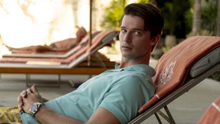 Saxon sitting on a sun lounger wearing a mint green t-shirt