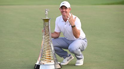 Rory McIlroy poses with the Race to Dubai trophy