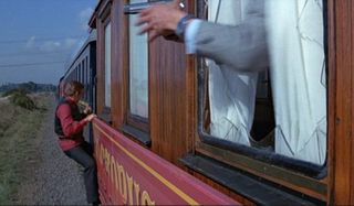 James Bond hangs from a train in Octopussy