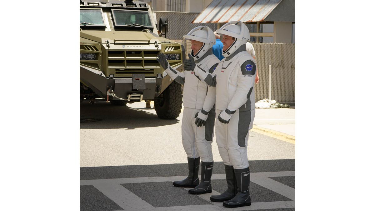 NASA astronauts Bob Behnken and Doug Hurley walk out of NASA's Astronaut Crew Quarters and take a Tesla Model X to Launch Pad 39A during a dry-run test of their SpaceX Crew Dragon Demo-2 flight on May 23, 2020 at the Kennedy Space Center in Florida.