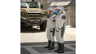 NASA astronauts Bob Behnken and Doug Hurley walk out of NASA's Astronaut Crew Quarters and take a Tesla Model X to Launch Pad 39A during a dry-run test of their SpaceX Crew Dragon Demo-2 flight on May 23, 2020 at the Kennedy Space Center in Florida.