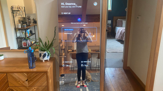 The author setting up her Fiture Interactive Smart Fitness Mirror