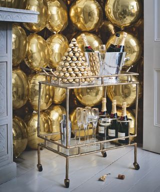 Bar cart, gold balloons, chocolate