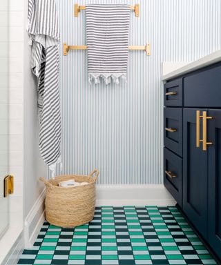 Small bathroom with striped walls and colorful check stripes floor tiles