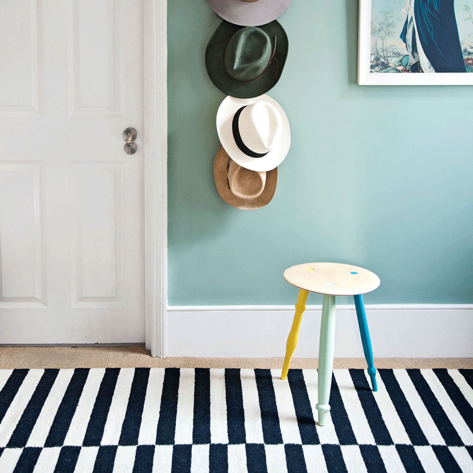 Blue walls with black and white rug