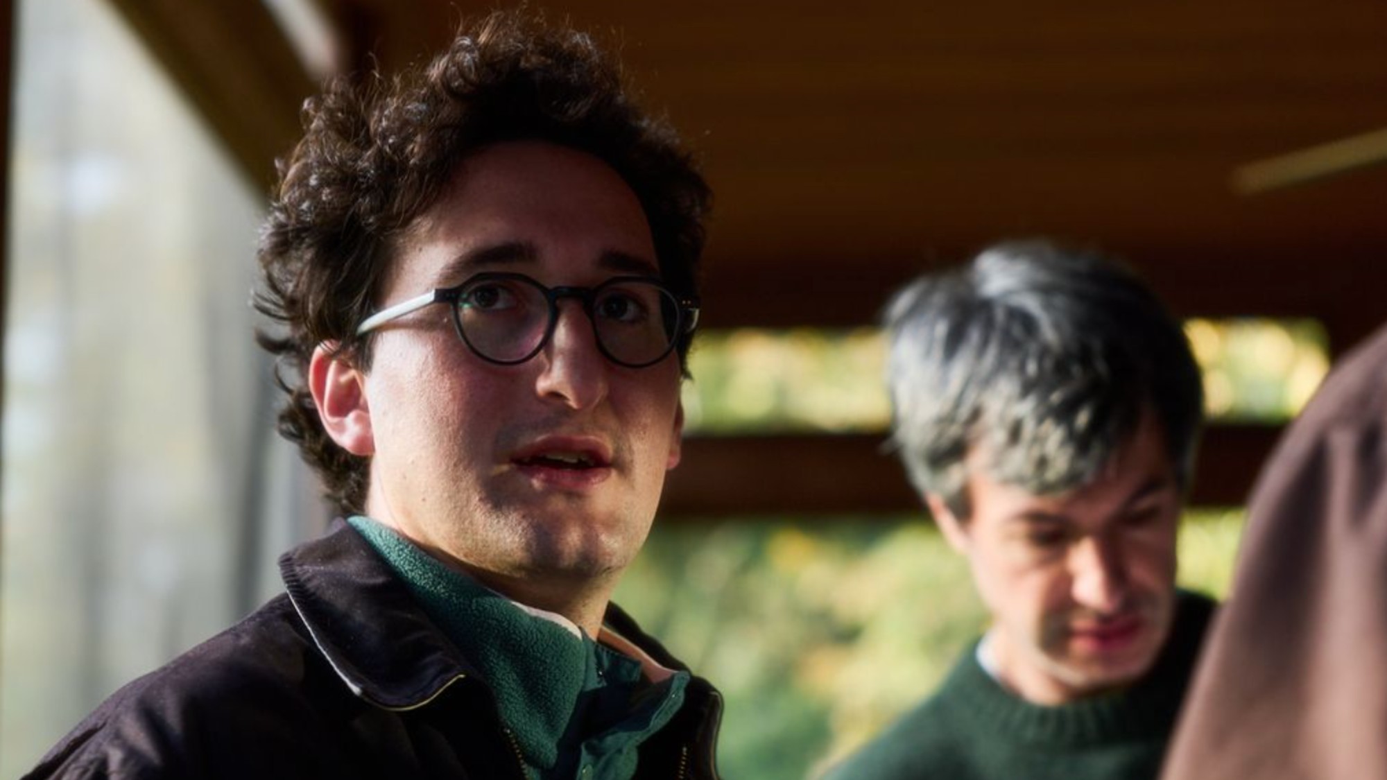 Lance Oppenheim, with Nathan Fielder in the background, directing You Can See Everything.