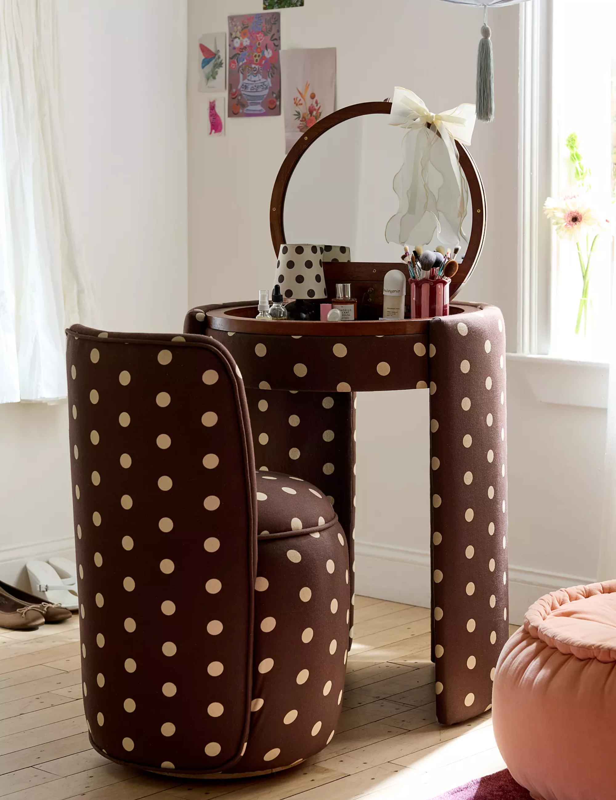 Polka dot Jane Vanity set by Urban Outfitters pictured in a bright bedroom with light hardwood floors and white walls accented with wall art