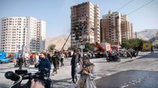 Iranian news broadcasters outside Tehran building hit by Israeli airstrike