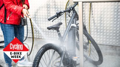 Female cyclist cleaning an electric bike