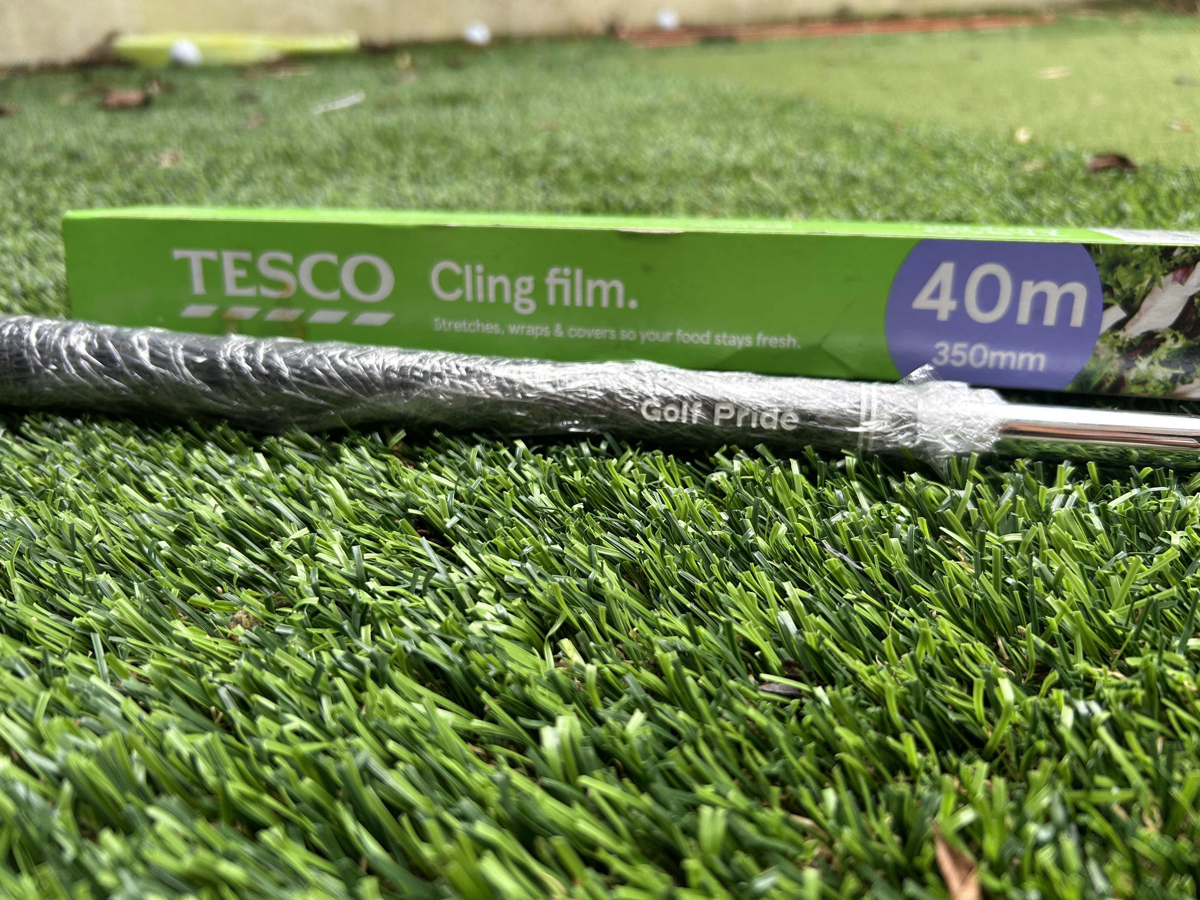 A golf pride grip covered in cling film